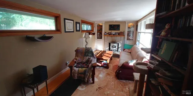 a view of a livingroom with furniture and a window