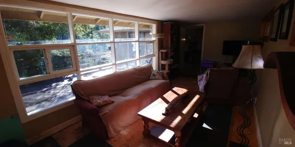 a living room with furniture and a window
