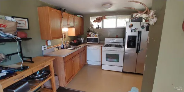 a kitchen with a stove and a refrigerator