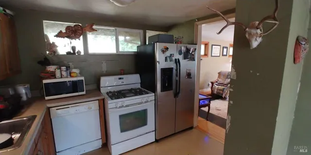 a kitchen with a stove and a refrigerator