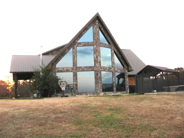a backyard of a house with table and chairs