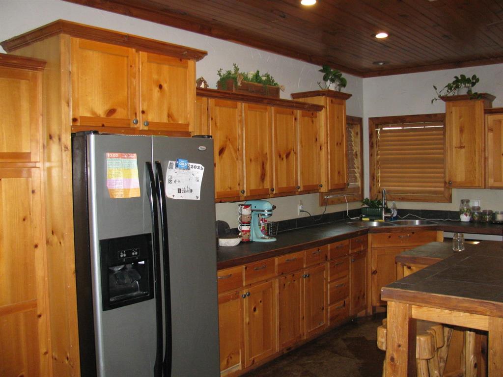 941 North 4420th Road Valliant, OK 74764 - Photo 5 of 40 a bathroom with a sink a mirror and shower