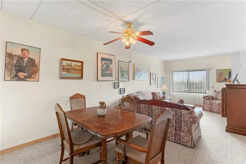 a view of a dining room with furniture window and outside view