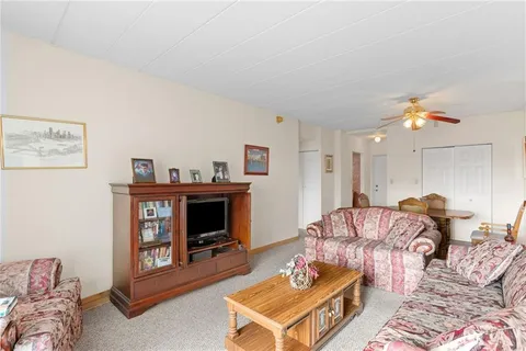 a living room with furniture and painting on the wall