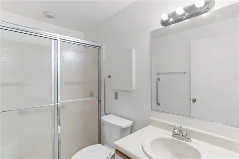 a bathroom with a shower a toilet and sink