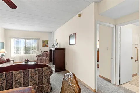 a living room with furniture a rug and white walls