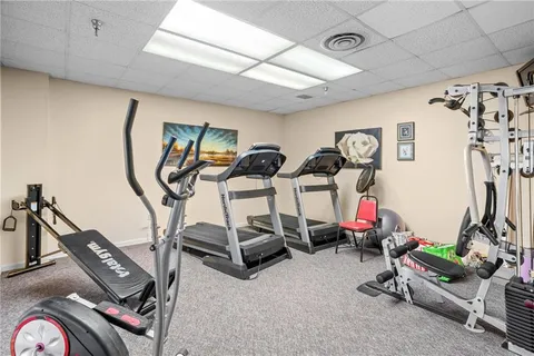 a room with furniture a baby crib and a couch