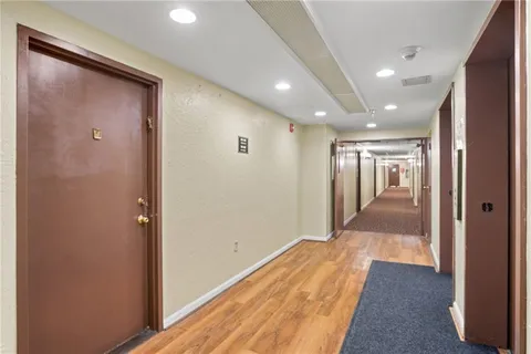 a view of hallway with wooden floor