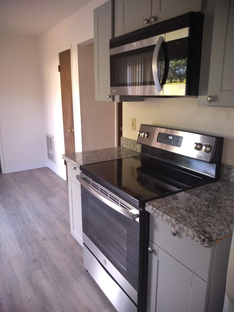 698 Danforth Drive Sunnyvale, CA 94087 - Photo 8 of 23 a kitchen with granite countertop a stove and a microwave