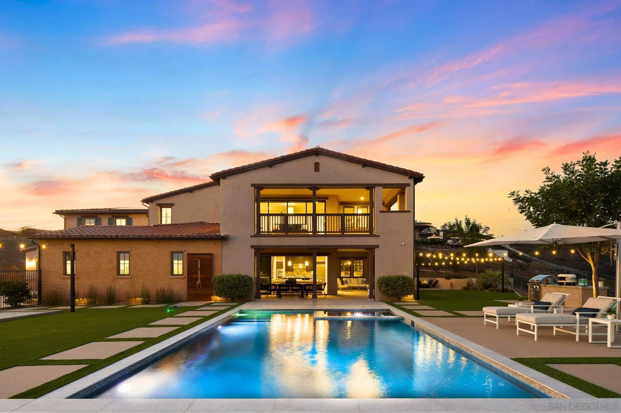 a view of a house with swimming pool and sitting area