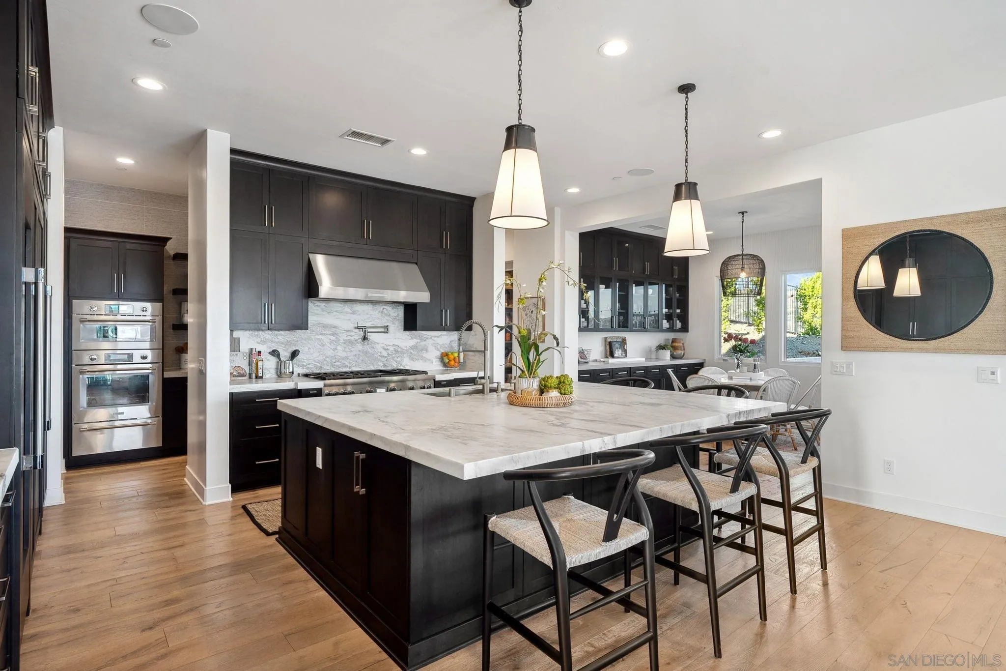 3801 Rancho Summit Drive Encinitas, CA 92024 - Photo 5 of 10 a kitchen with a table chairs stove and refrigerator