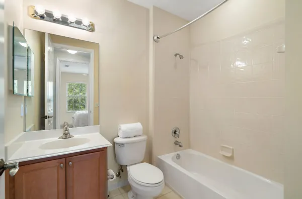 a bathroom with a toilet a sink and mirror