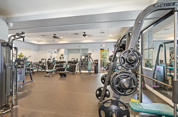 a room with lots of tables a large window and chairs