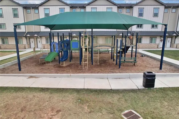 a view of a patio with a table and chairs under an umbrella