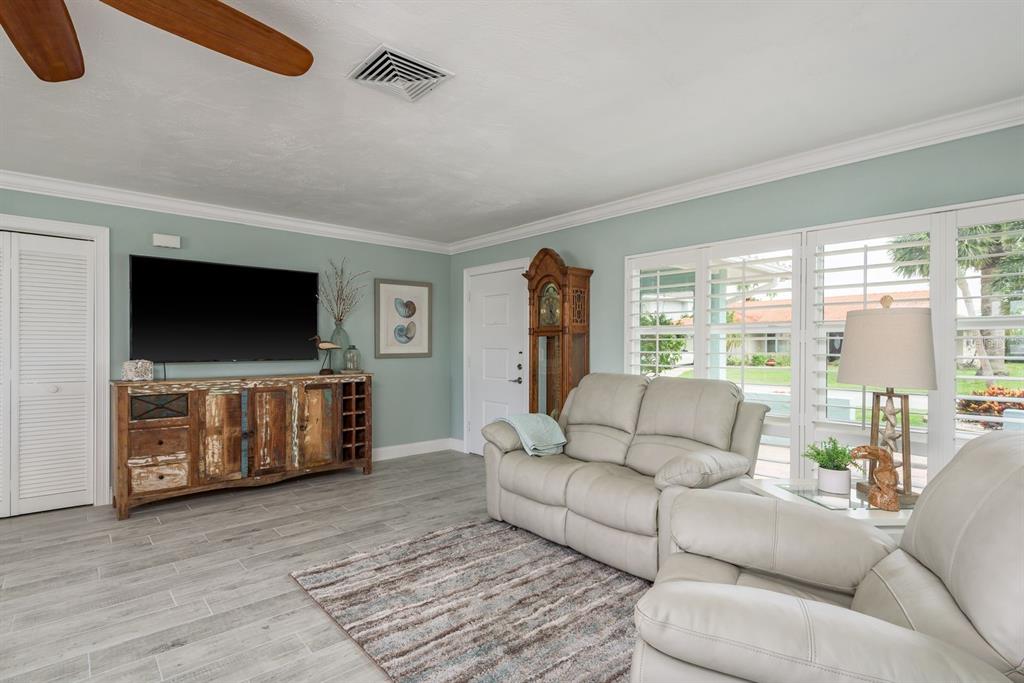3301 Seaway Drive New Port Richey, FL 34652 - Photo 11 of 53 a living room with furniture and a flat screen tv