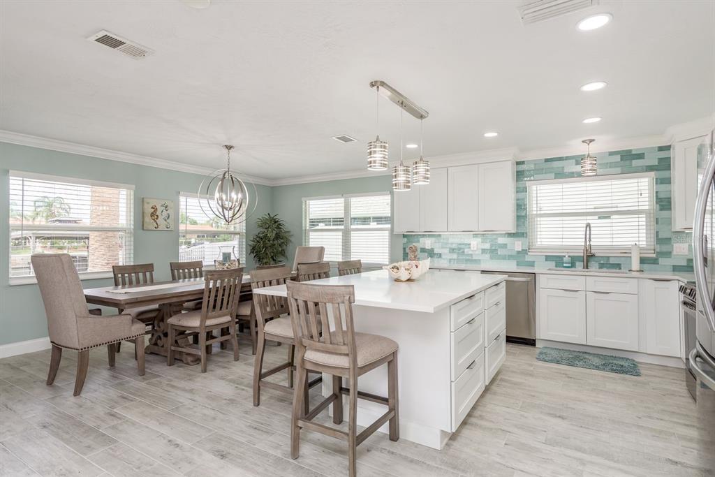 3301 Seaway Drive New Port Richey, FL 34652 - Photo 12 of 53 a large kitchen with kitchen island a sink table and chairs