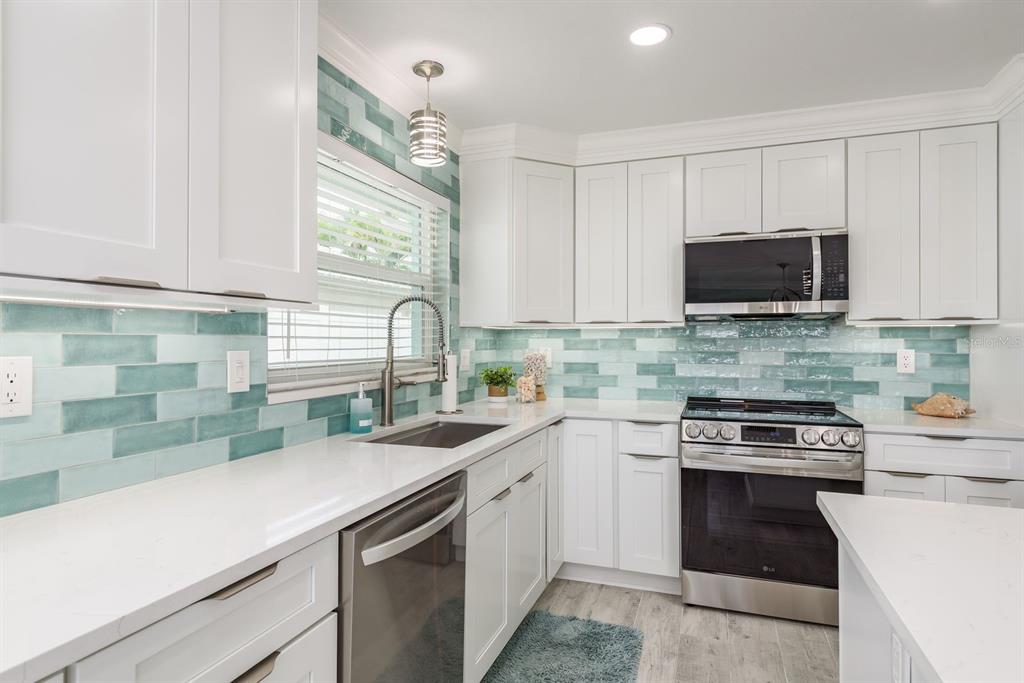 3301 Seaway Drive New Port Richey, FL 34652 - Photo 14 of 53 a kitchen with a sink stove and microwave