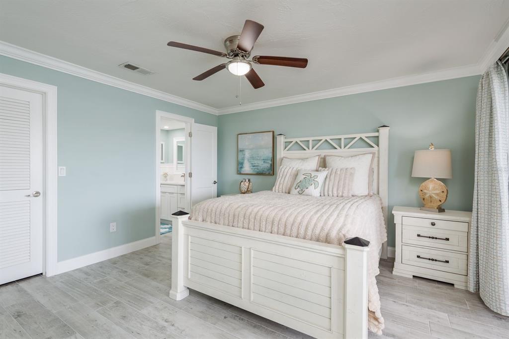 3301 Seaway Drive New Port Richey, FL 34652 - Photo 20 of 53 a bedroom with a large bed and a dresser
