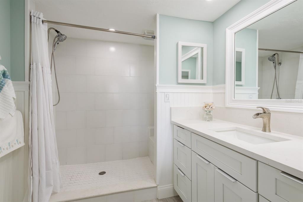 3301 Seaway Drive New Port Richey, FL 34652 - Photo 21 of 53 a bathroom with a shower sink and mirror
