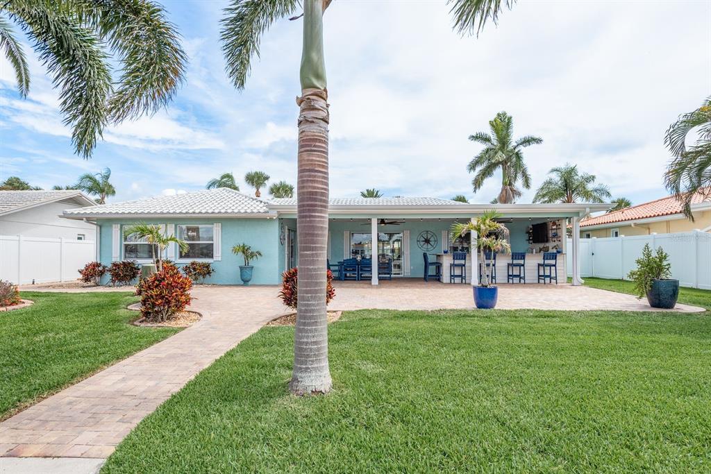 3301 Seaway Drive New Port Richey, FL 34652 - Photo 33 of 53 a front view of a house with a garden and patio