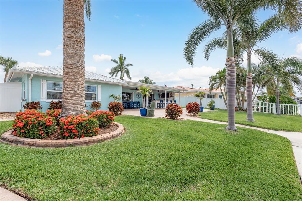 3301 Seaway Drive New Port Richey, FL 34652 - Photo 37 of 53 a front view of a house with a garden and patio