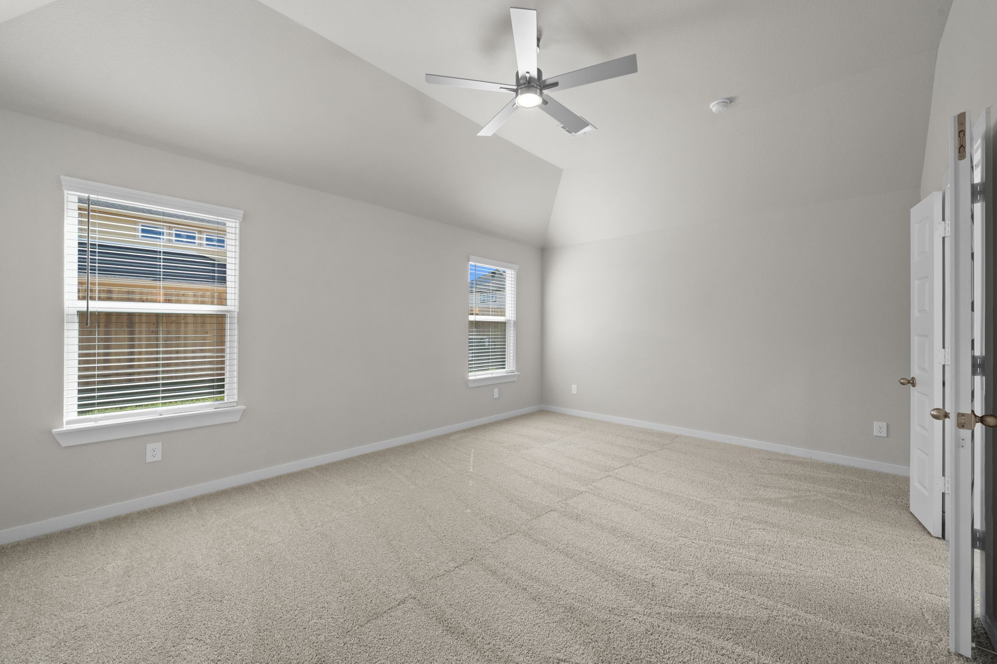 3023 Boulder Rdg Drive Rosenberg, TX 77471 - Photo 12 of 34 an empty room with chandelier fan and windows