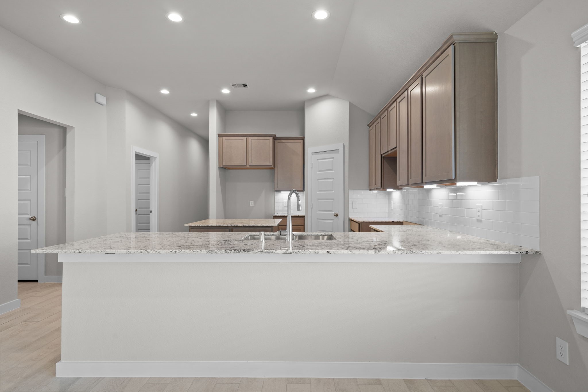 3023 Boulder Rdg Drive Rosenberg, TX 77471 - Photo 2 of 34 a large kitchen with stainless steel appliances granite countertop a sink a stove a microwave and island