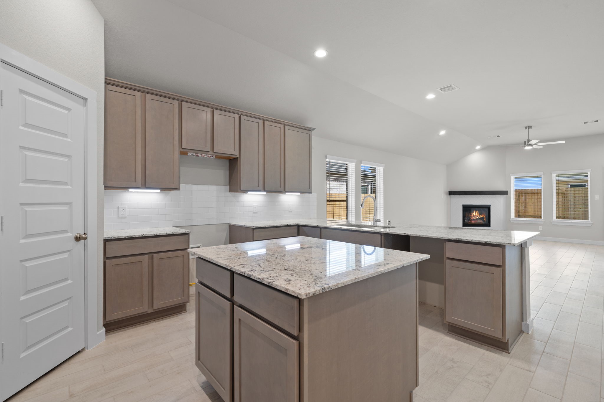 3023 Boulder Rdg Drive Rosenberg, TX 77471 - Photo 3 of 34 a kitchen with kitchen island granite countertop a sink stove and refrigerator