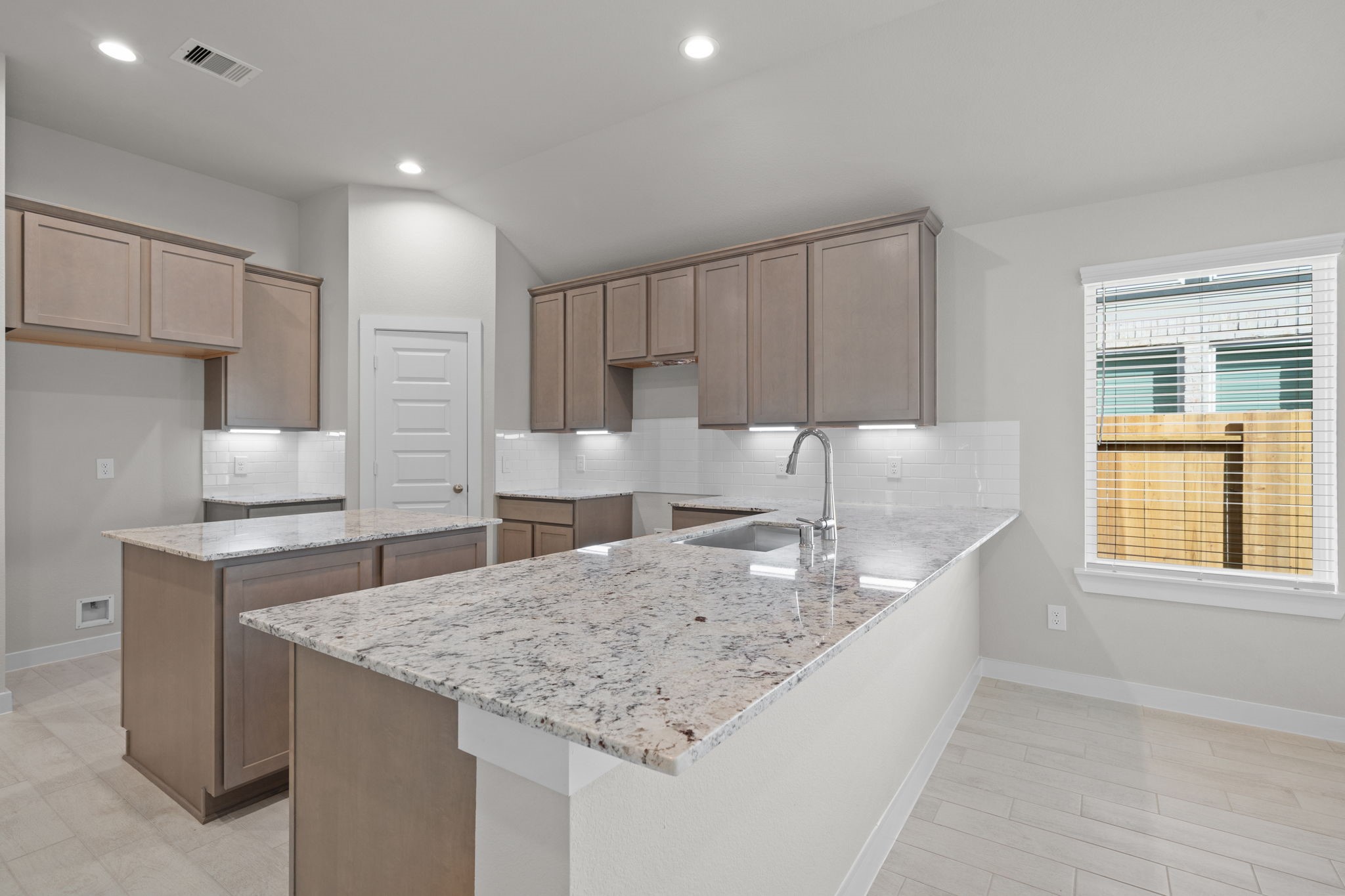 3023 Boulder Rdg Drive Rosenberg, TX 77471 - Photo 6 of 34 a kitchen with granite countertop a sink a counter top space and cabinets