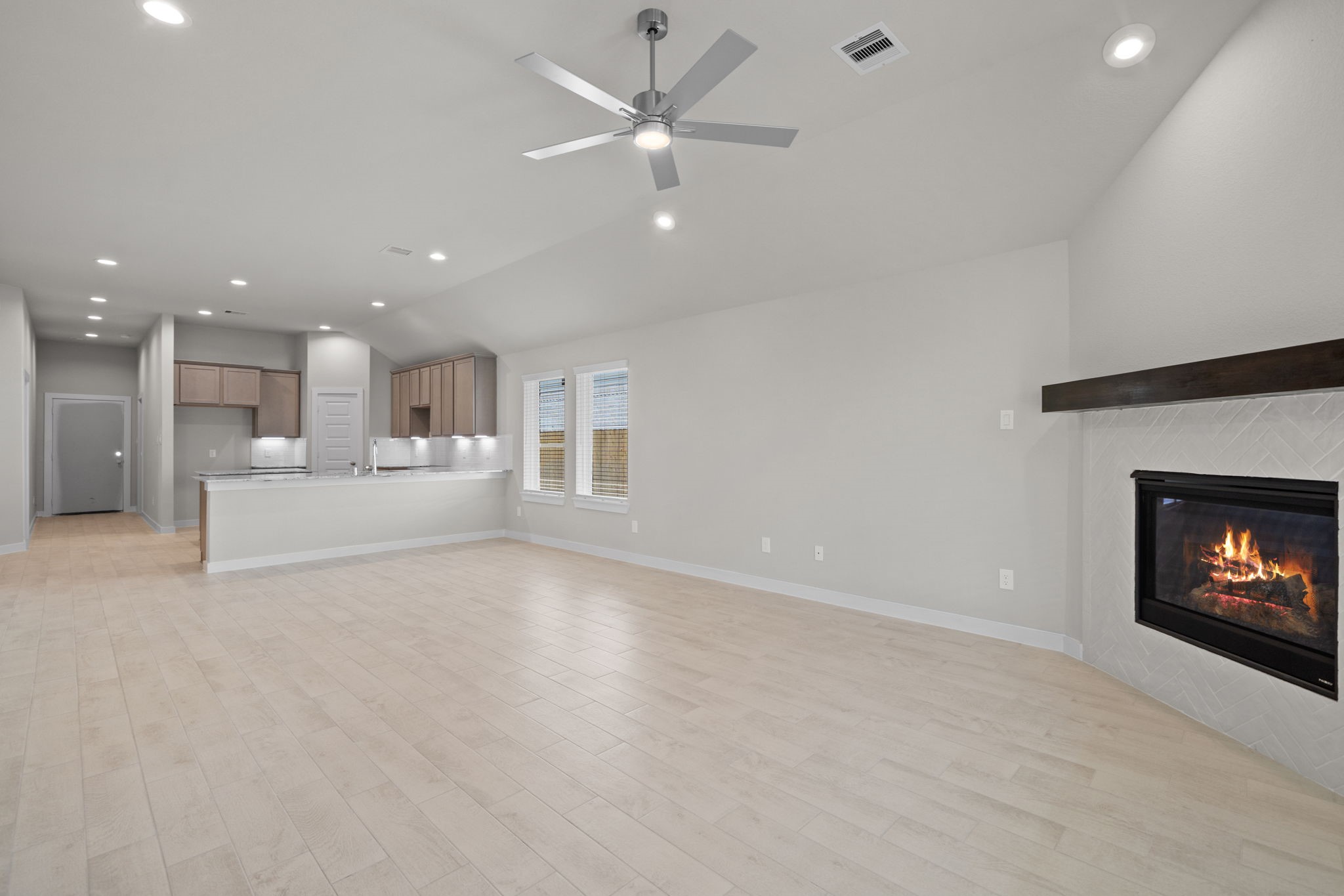3023 Boulder Rdg Drive Rosenberg, TX 77471 - Photo 7 of 34 a view of a livingroom with a fireplace a ceiling fan and a kitchen view