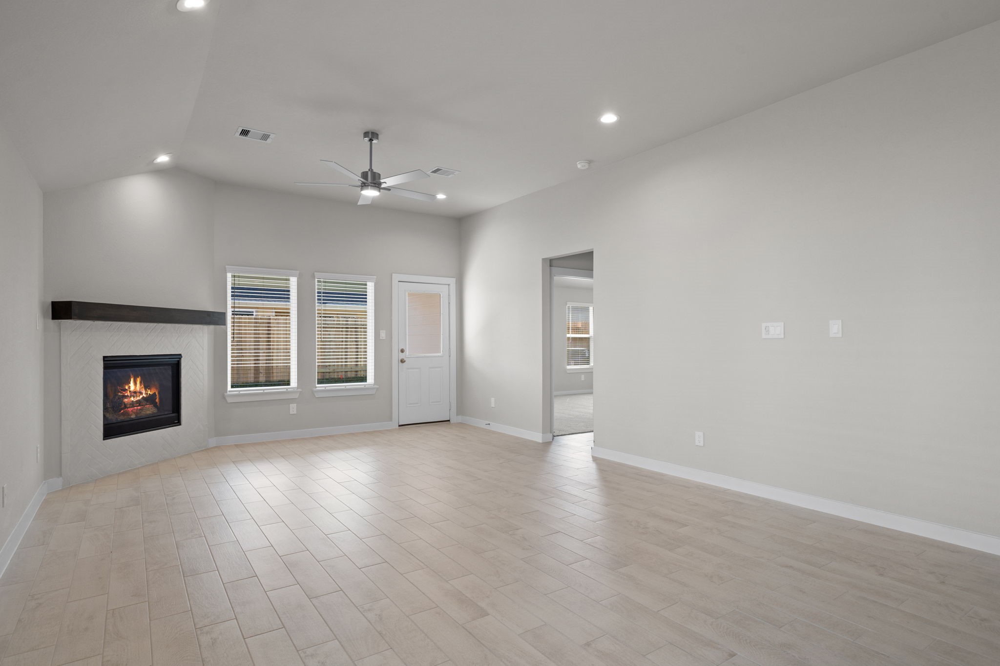 3023 Boulder Rdg Drive Rosenberg, TX 77471 - Photo 9 of 34 an empty room with wooden floor fireplace and windows