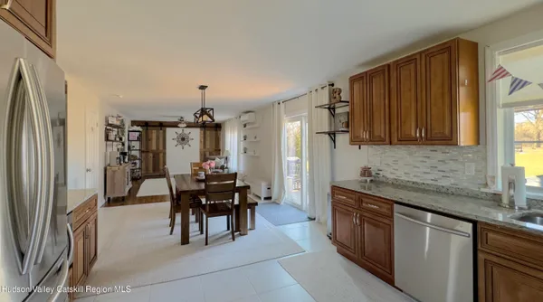 a view of a a dining room with furniture window and wooden floor