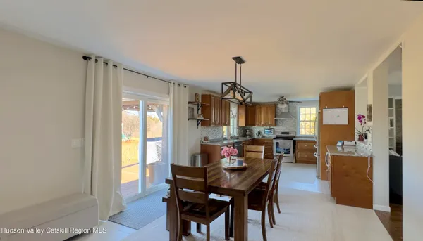 a view of swimming pool with yard and tree in the background