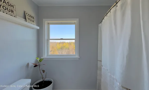 a view of swimming pool with an outdoor seating and a many windows