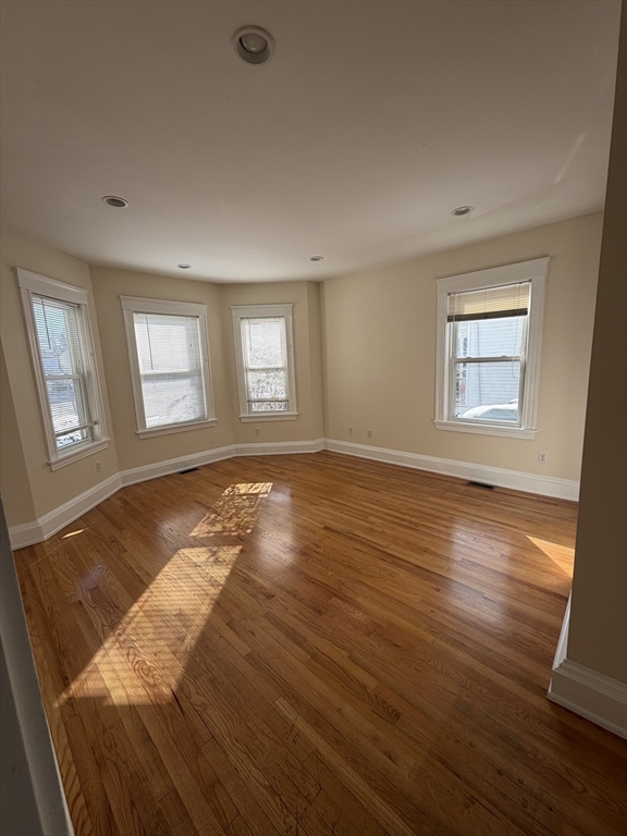 555 Heath Street, Unit 1 Brookline, MA 02467 - Photo 2 of 7 a view of a room with wooden floor and window