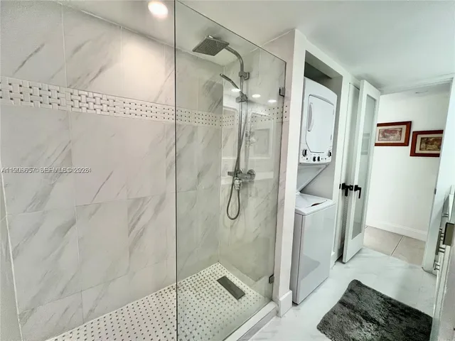 a bathroom with a glass shower door