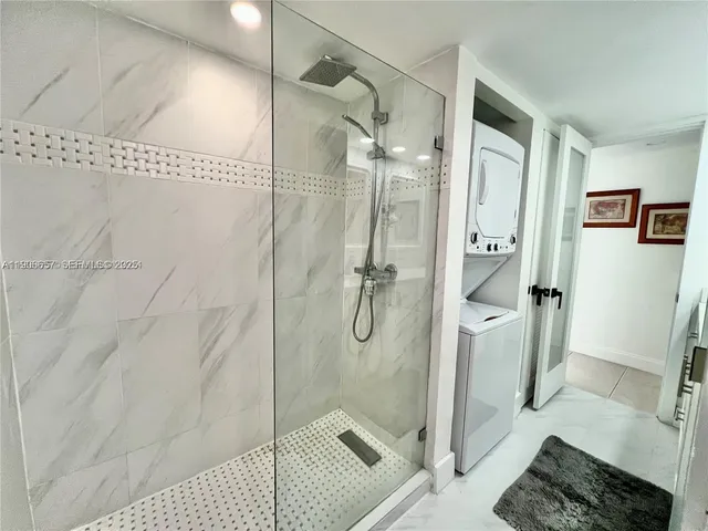 a bathroom with a glass shower door