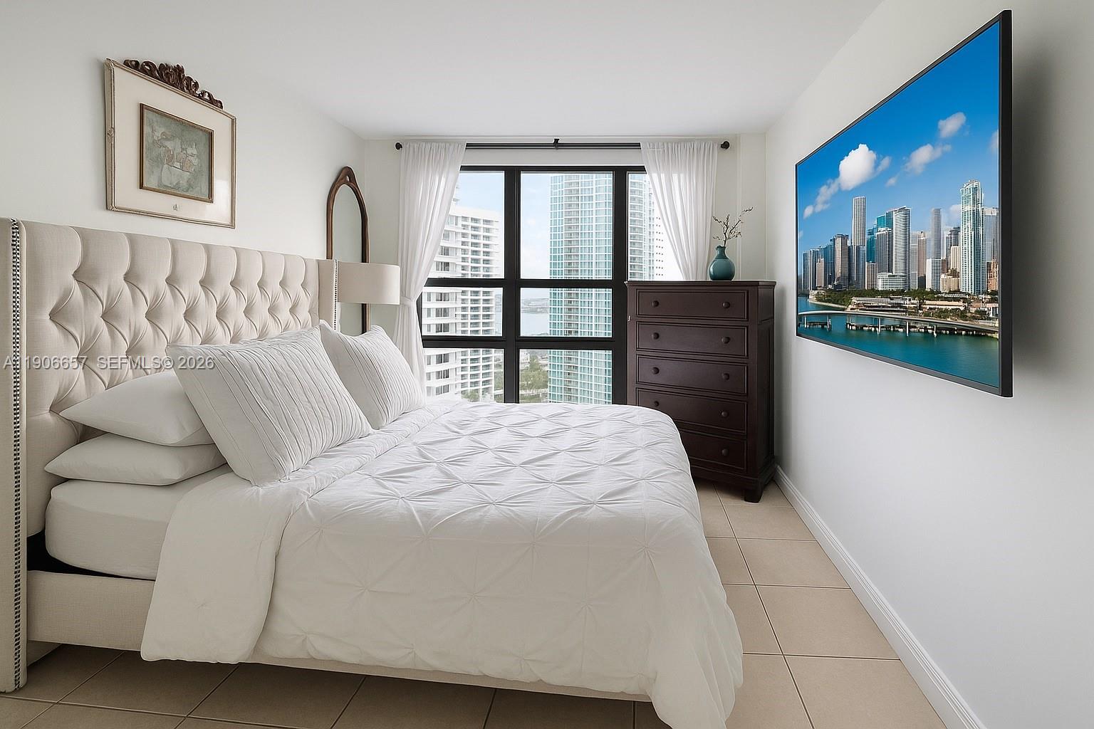 600 Northeast 36th Street, Unit 2011 Miami, FL 33137 - Photo 14 of 49 a bedroom with a bed next to a window with outer view