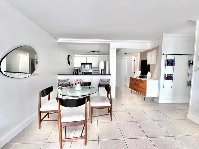 a dining room with furniture and a view of kitchen