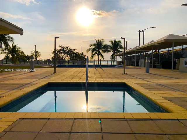 a living room with lots of furniture and floor to ceiling window
