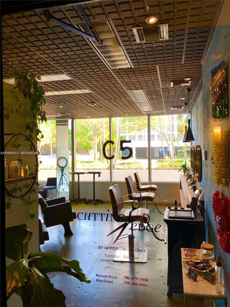 600 Northeast 36th Street, Unit 2011 Miami, FL 33137 - Photo 34 of 49 a living room with patio furniture and a chandelier