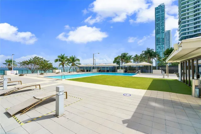 a view of swimming pool with outdoor seating and yard in back