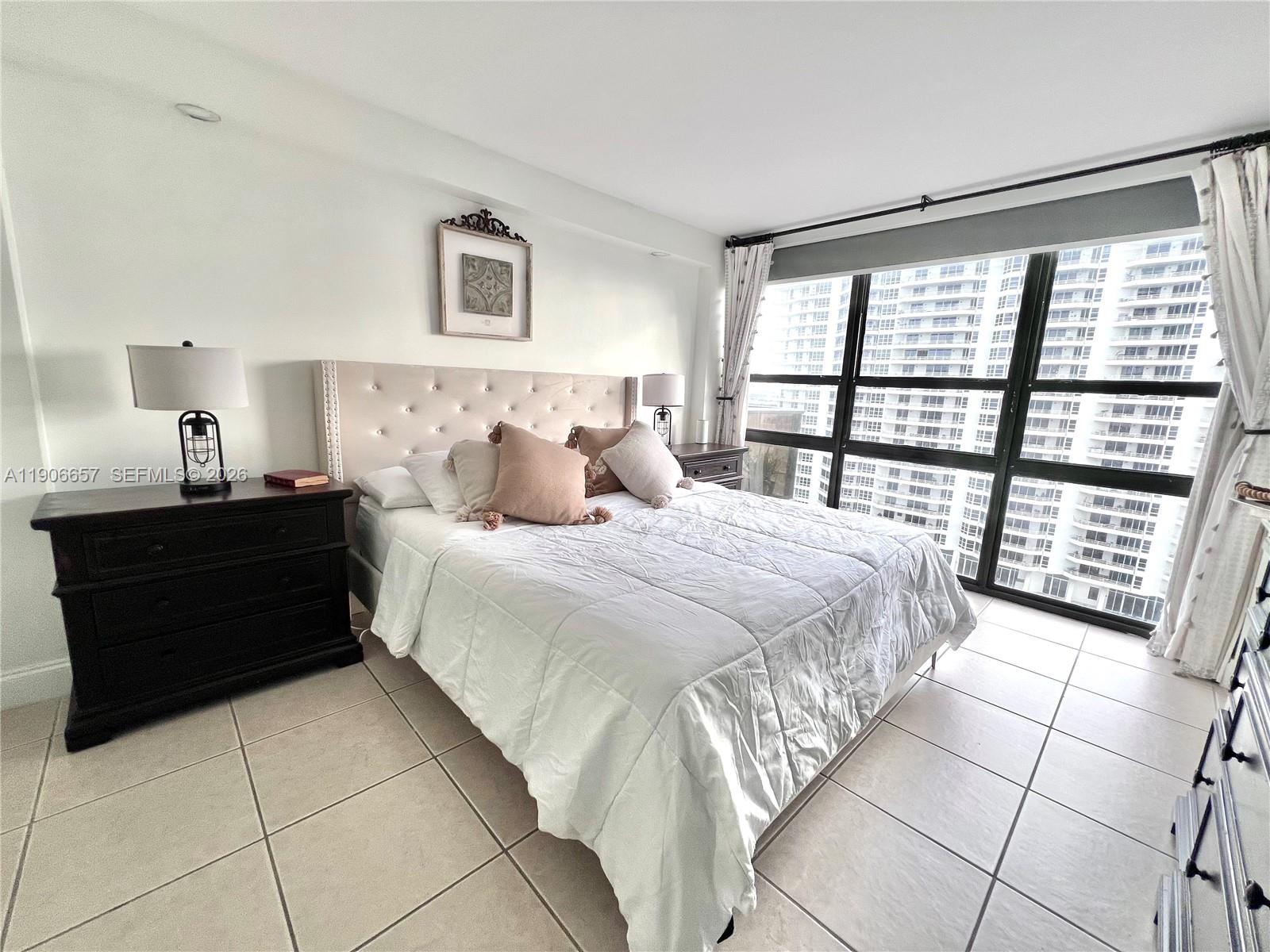 600 Northeast 36th Street, Unit 2011 Miami, FL 33137 - Photo 8 of 49 a bedroom with a bed and a large window