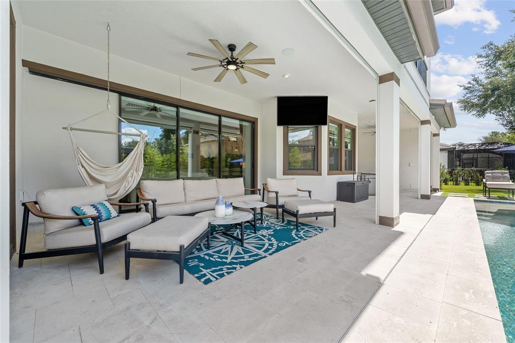 10175 Brocksport Circle Gotha, FL 34734 - Photo 50 of 54 a living room with furniture a flat screen tv and a large window