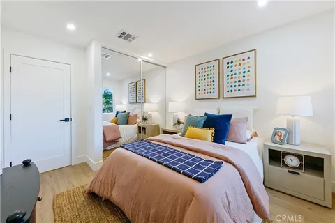 a bedroom with a bed and a potted plant