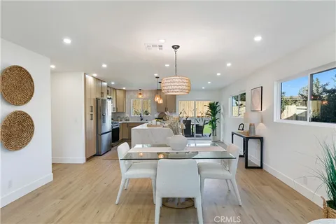 a dining room with furniture and wooden floor