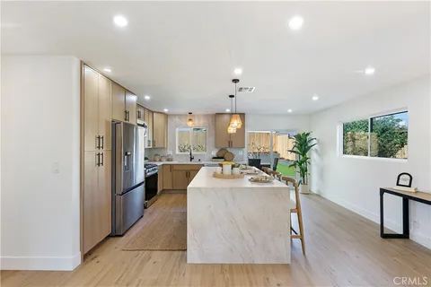 a large kitchen with a table and chairs
