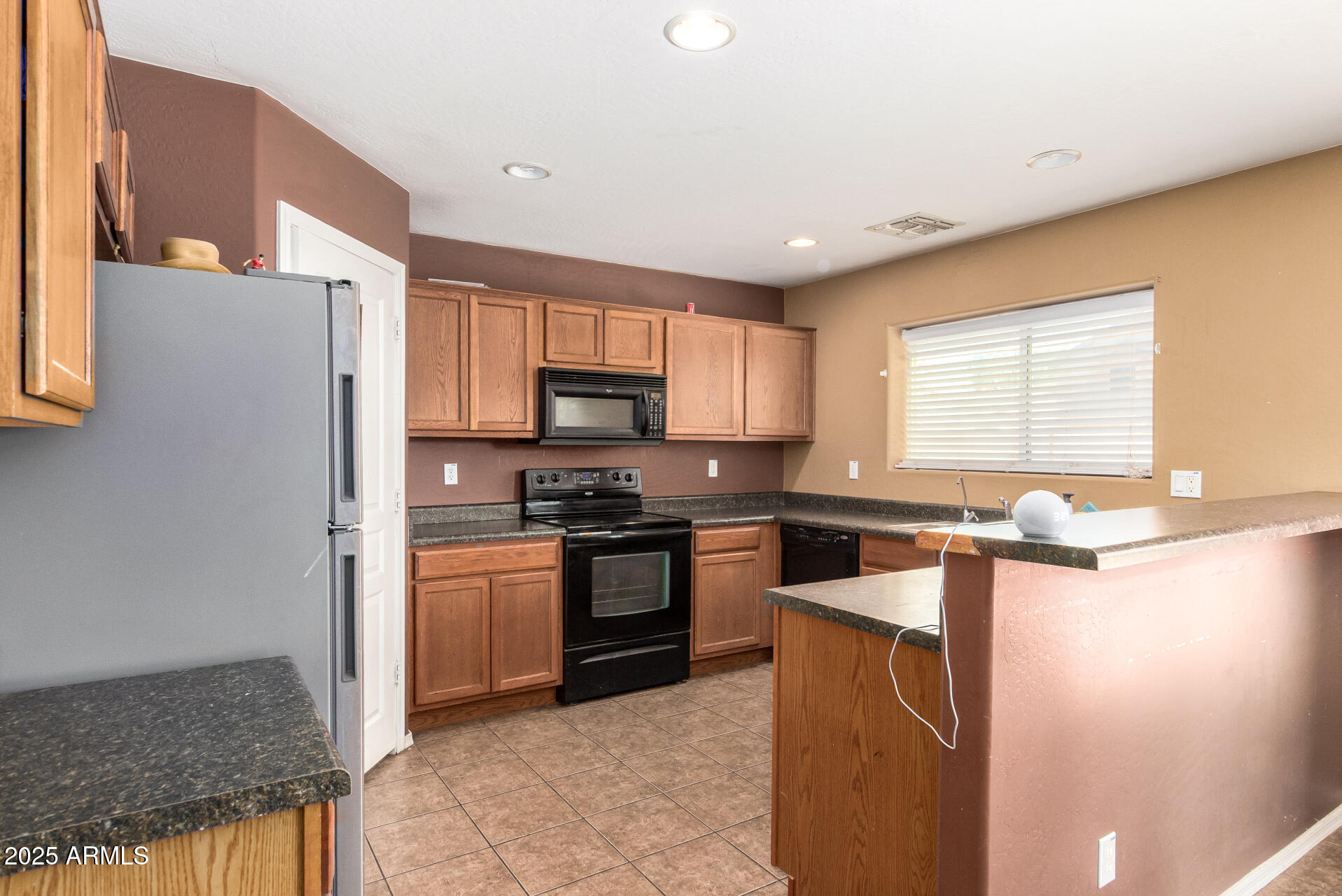 7229 West Crown King Road Phoenix, AZ 85043 - Photo 15 of 38 a kitchen with stainless steel appliances granite countertop a refrigerator a stove top oven a sink and dishwasher