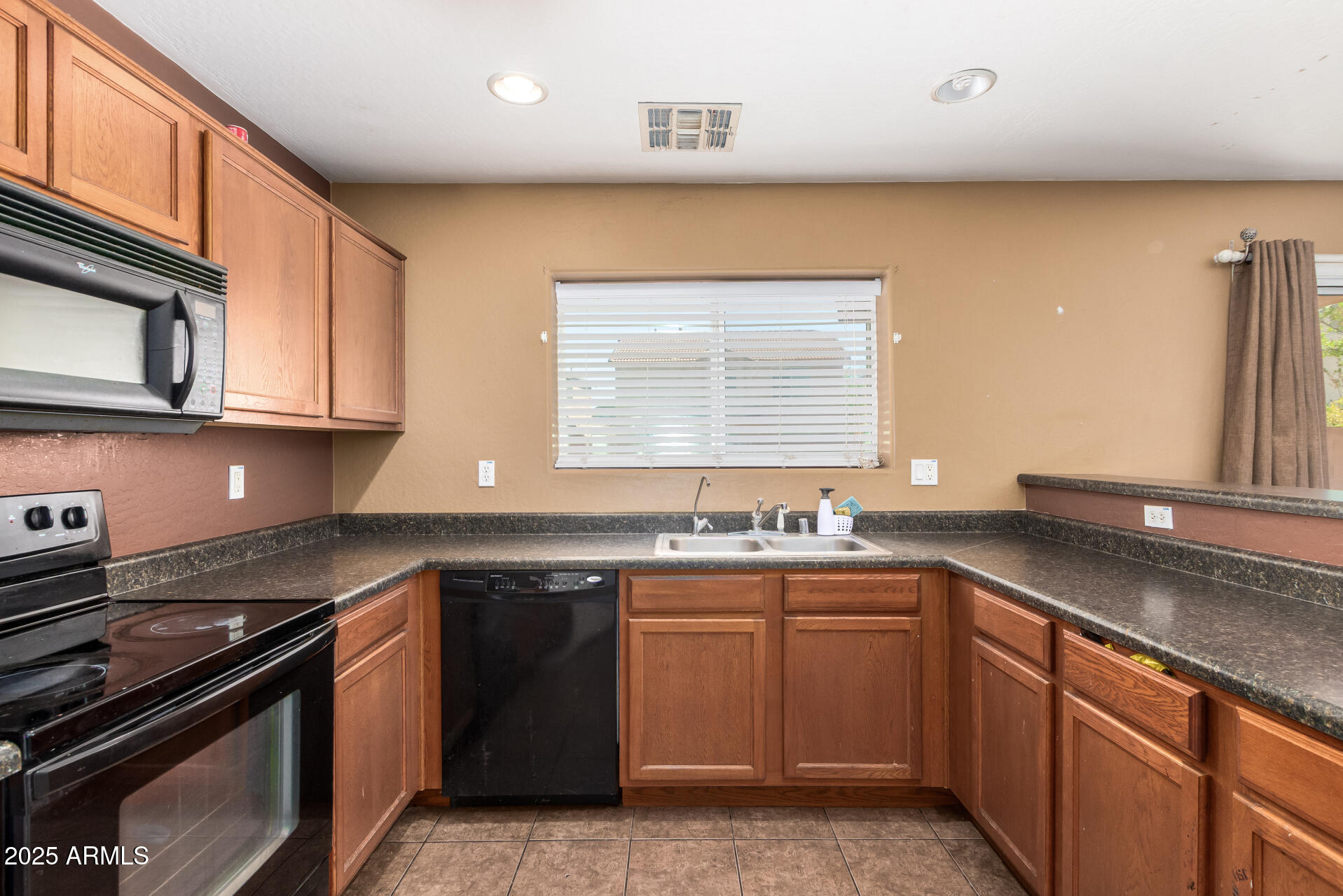 7229 West Crown King Road Phoenix, AZ 85043 - Photo 16 of 38 a kitchen with stainless steel appliances a sink stove and cabinets