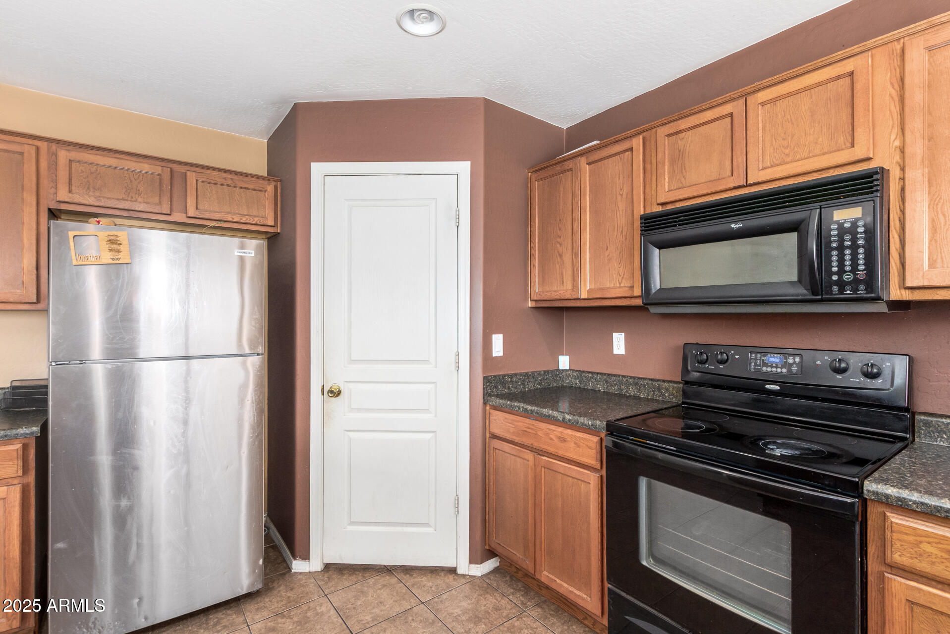 7229 West Crown King Road Phoenix, AZ 85043 - Photo 17 of 38 a kitchen with granite countertop cabinets stainless steel appliances and a granite counter tops